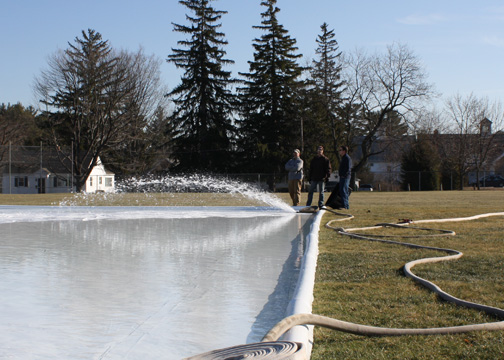 Photo of water coming out of hose to build ice skating rink