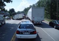 Photo taken from behind Police cruiser that6's parked behinid accident between Semi truck and large van