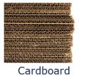 Photo of side-view of stack of numerous sheets of corrugated cardboard