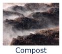 Photo of dirt that is emitting &quot;vapor&quot; as a byproduct of the compost process